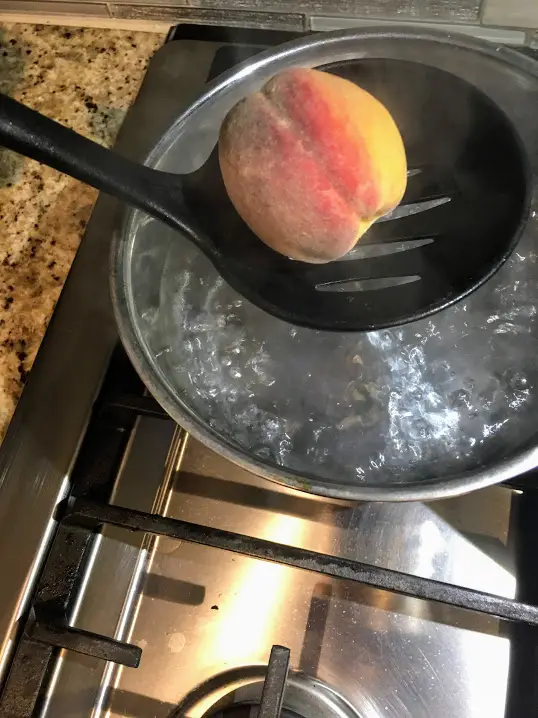 add ripe peach into boiling water