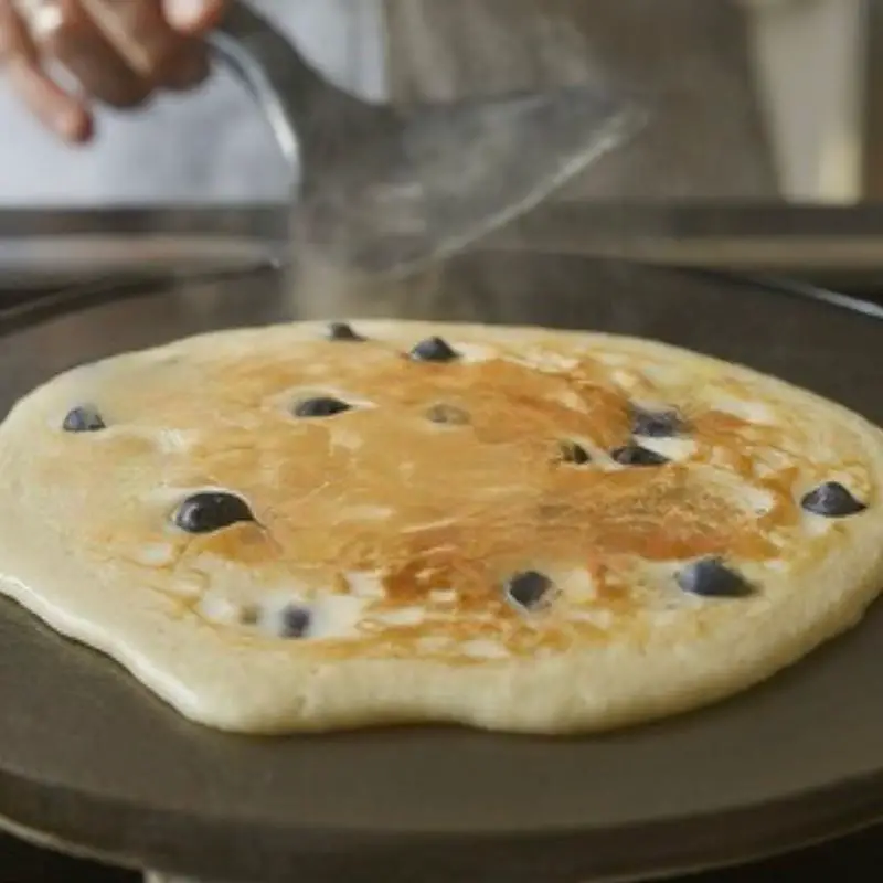 sugar free blueberry pancakes on a griddle